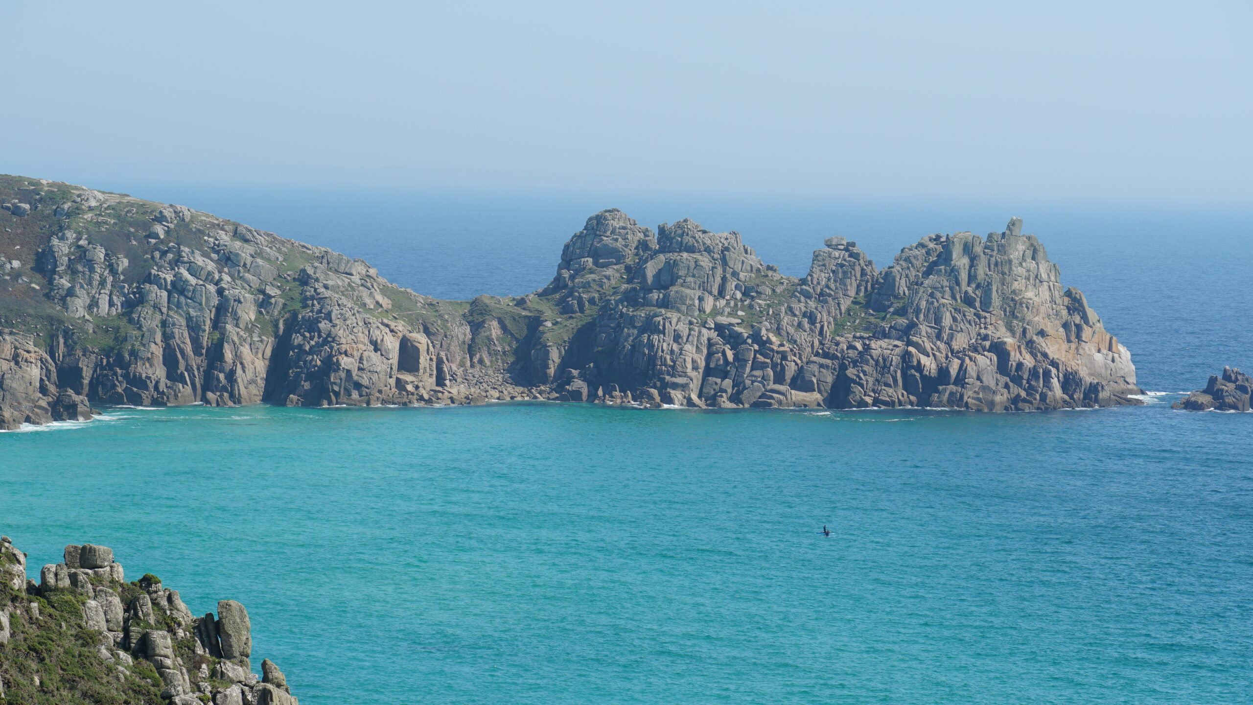 Families enjoying a sunny day on Porthcurno beach, Cornwall
