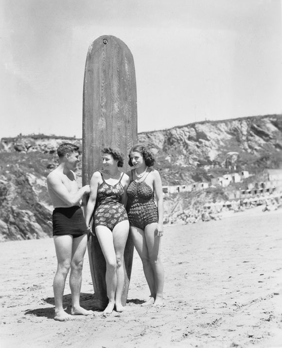 Surfers on the waves at Newquay in Cornwall