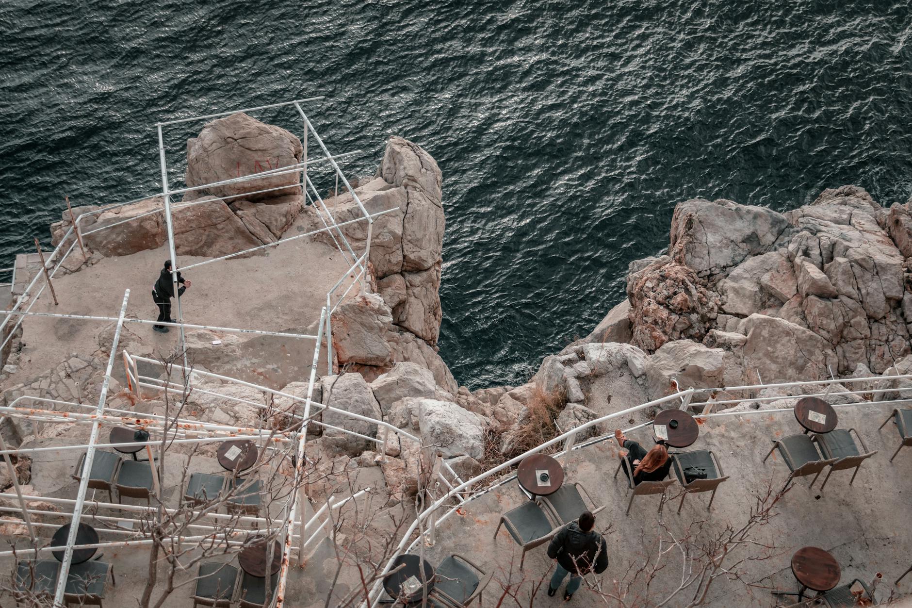 Visitors at a dramatic clifftop viewpoint overlooking the sea