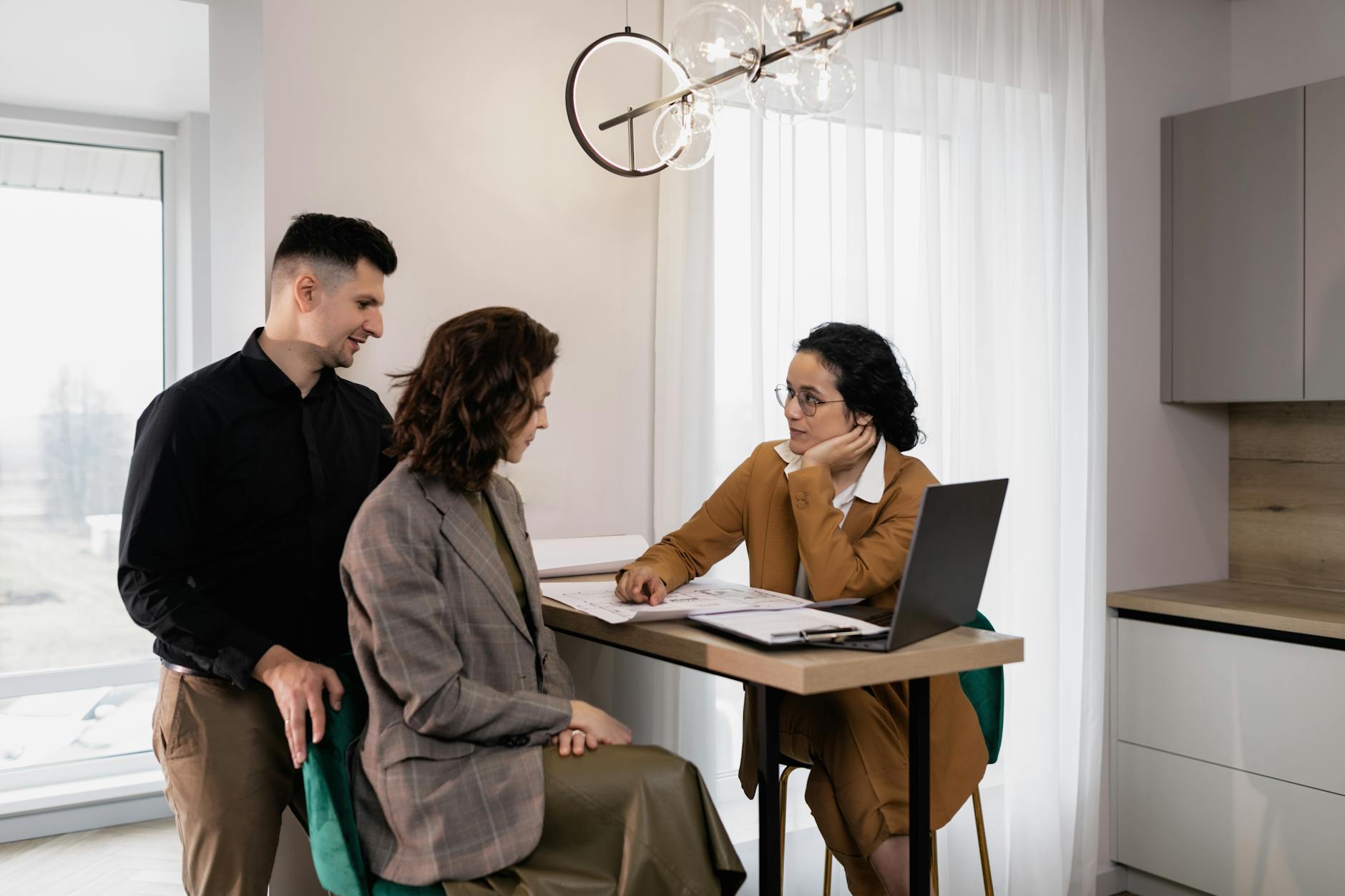 Estate agent in a meeting with clients at a desk