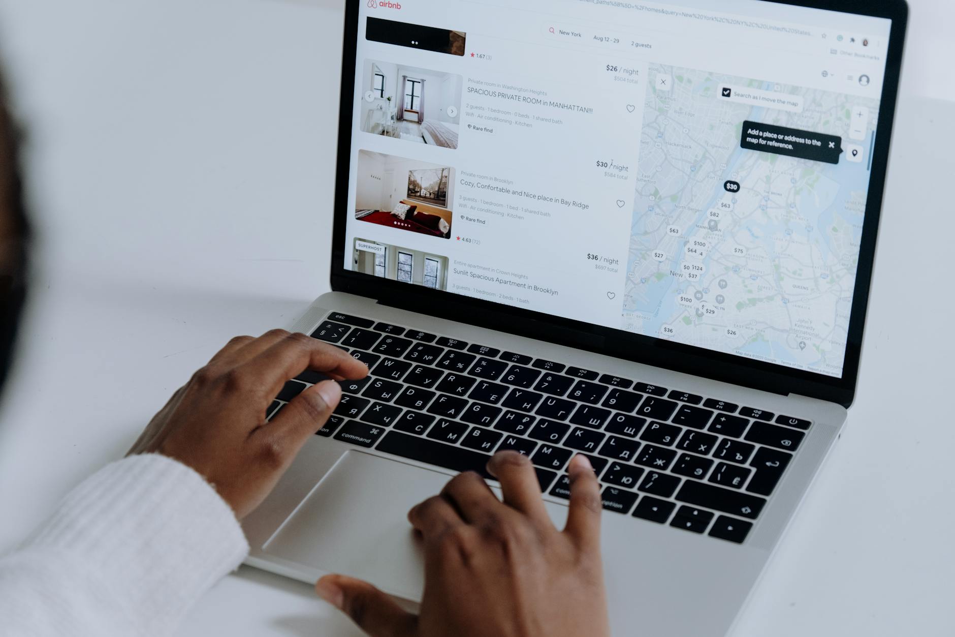 Person booking a holiday let on a laptop