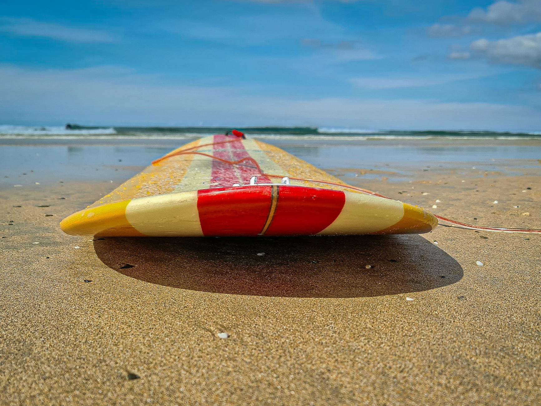 Surfboards lined up for rental on a beach near Newquay