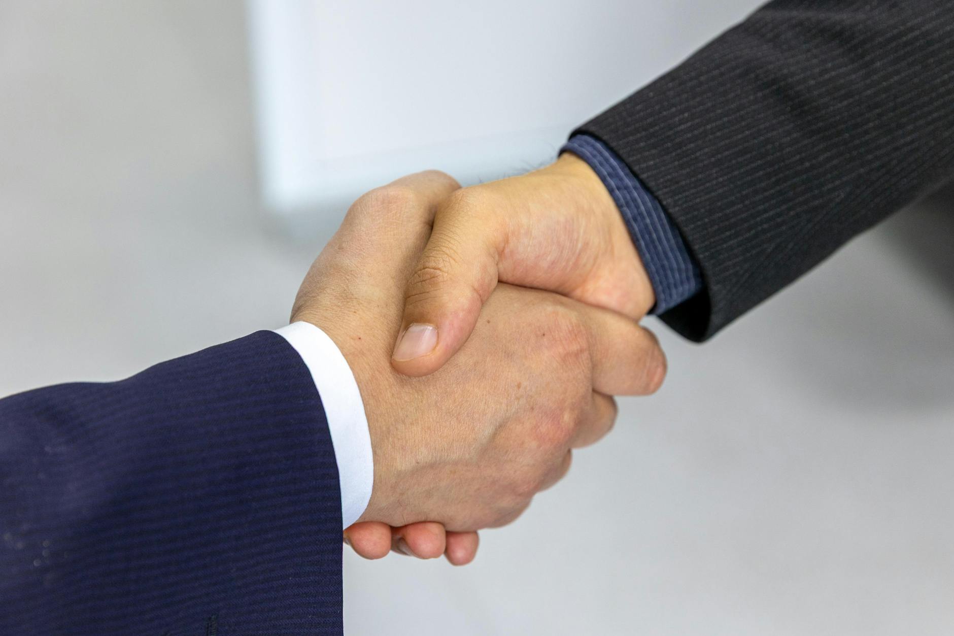 Two people shaking hands at a business meeting