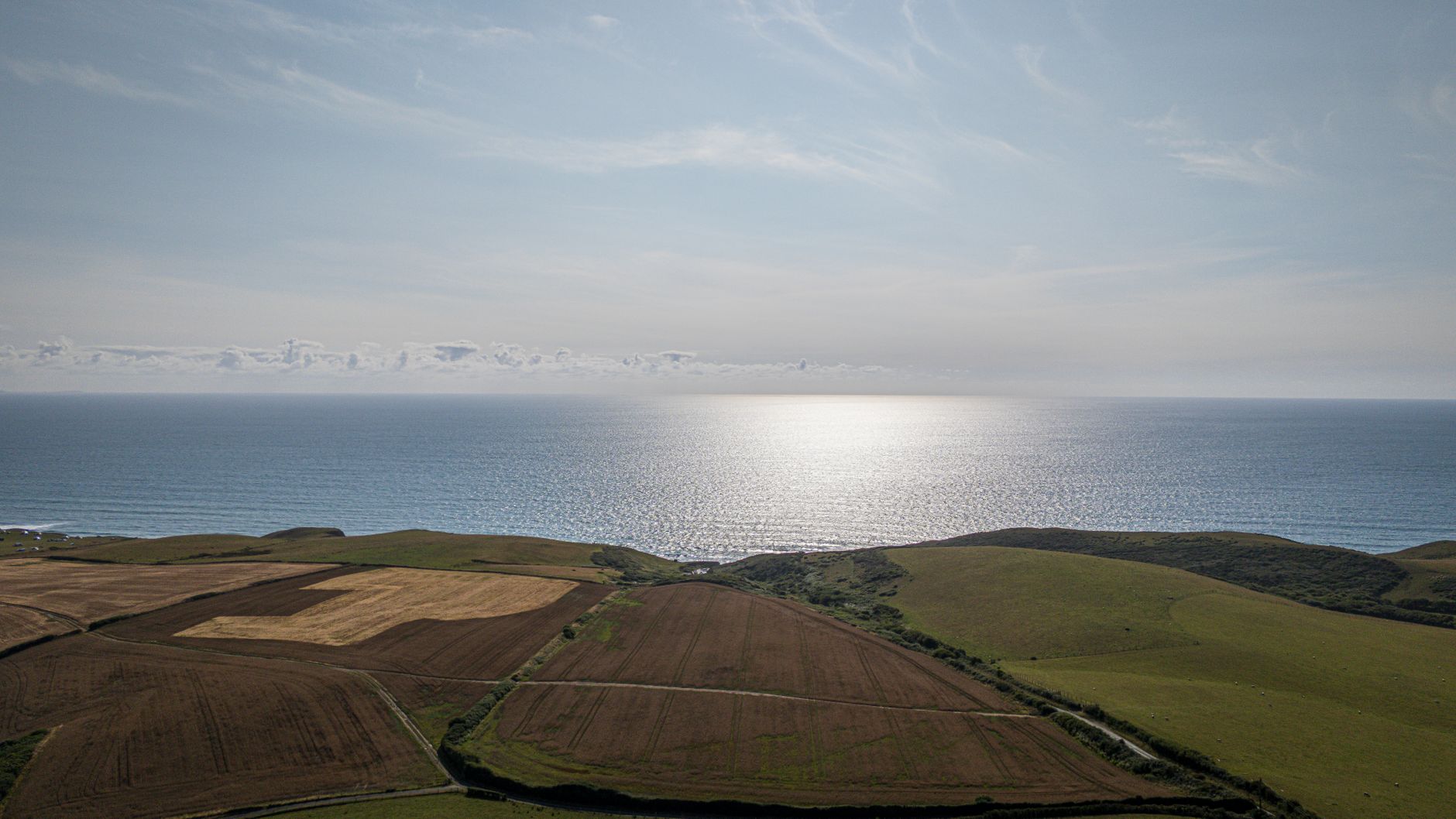 Aerial view of Cornwall green countryside and coastal landscape