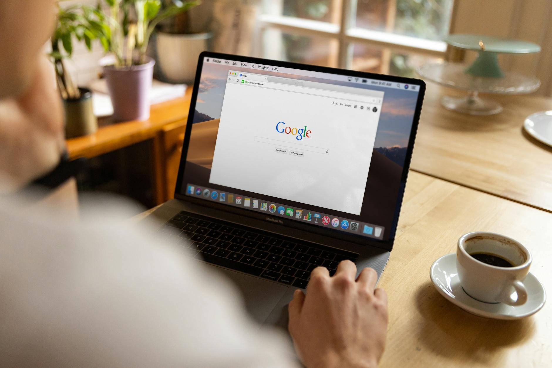 Business professional searching on Google on a laptop