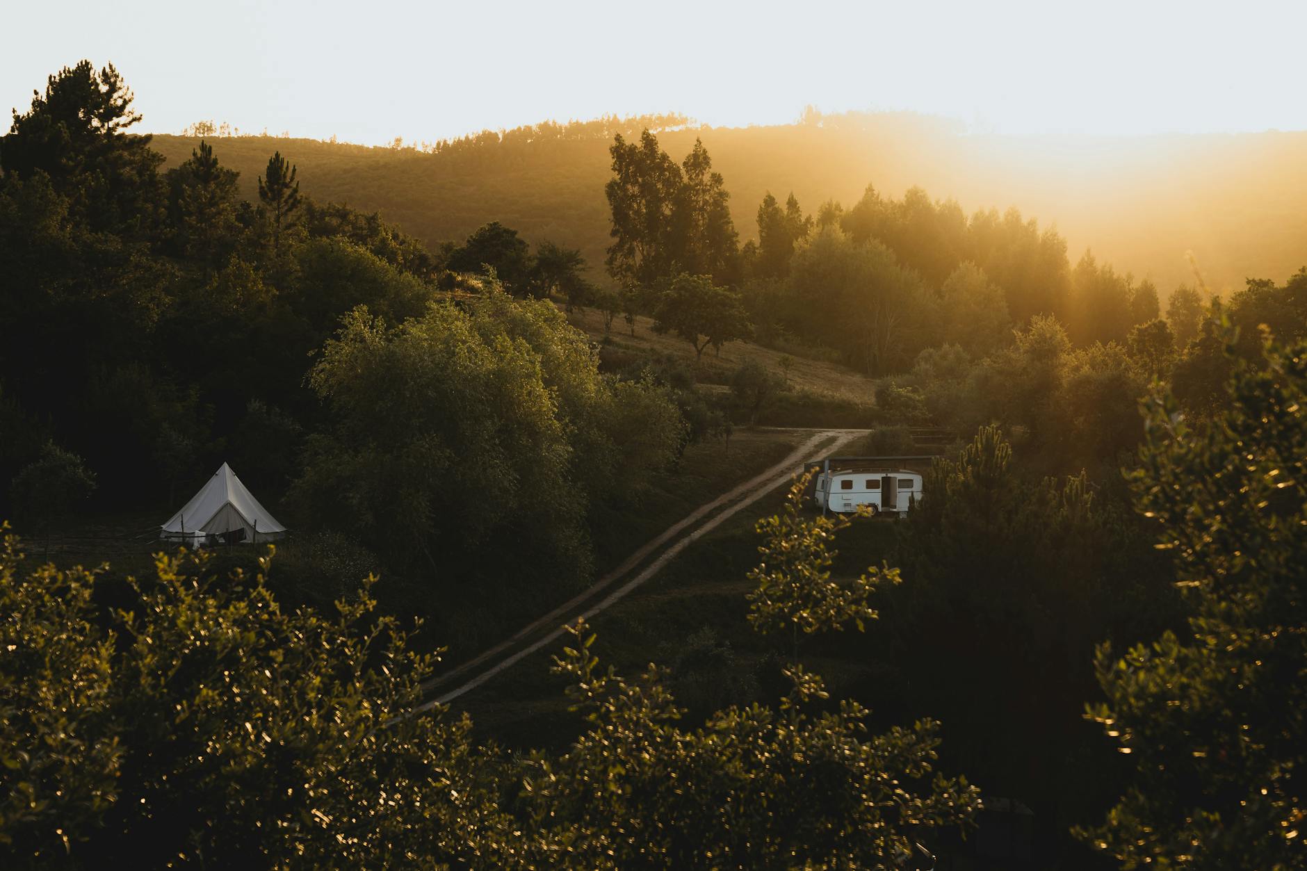 Luxury bell tent glamping in a field at sunset in Cornwall