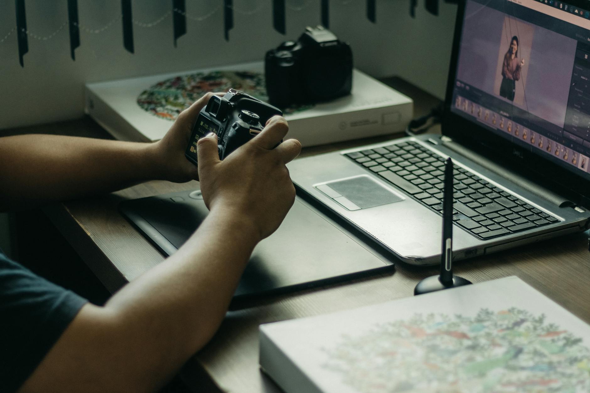 Photographer editing wedding photos on a laptop at a desk