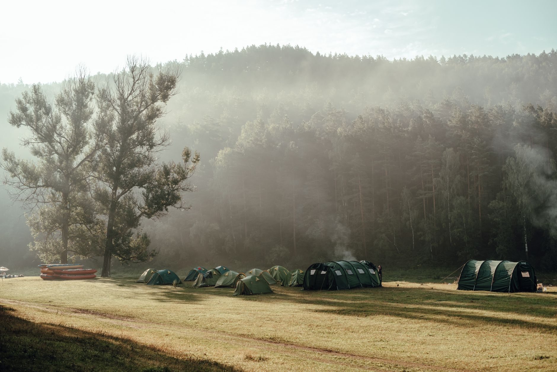 Tents at a campsite in the Cornwall countryside on a sunny morning