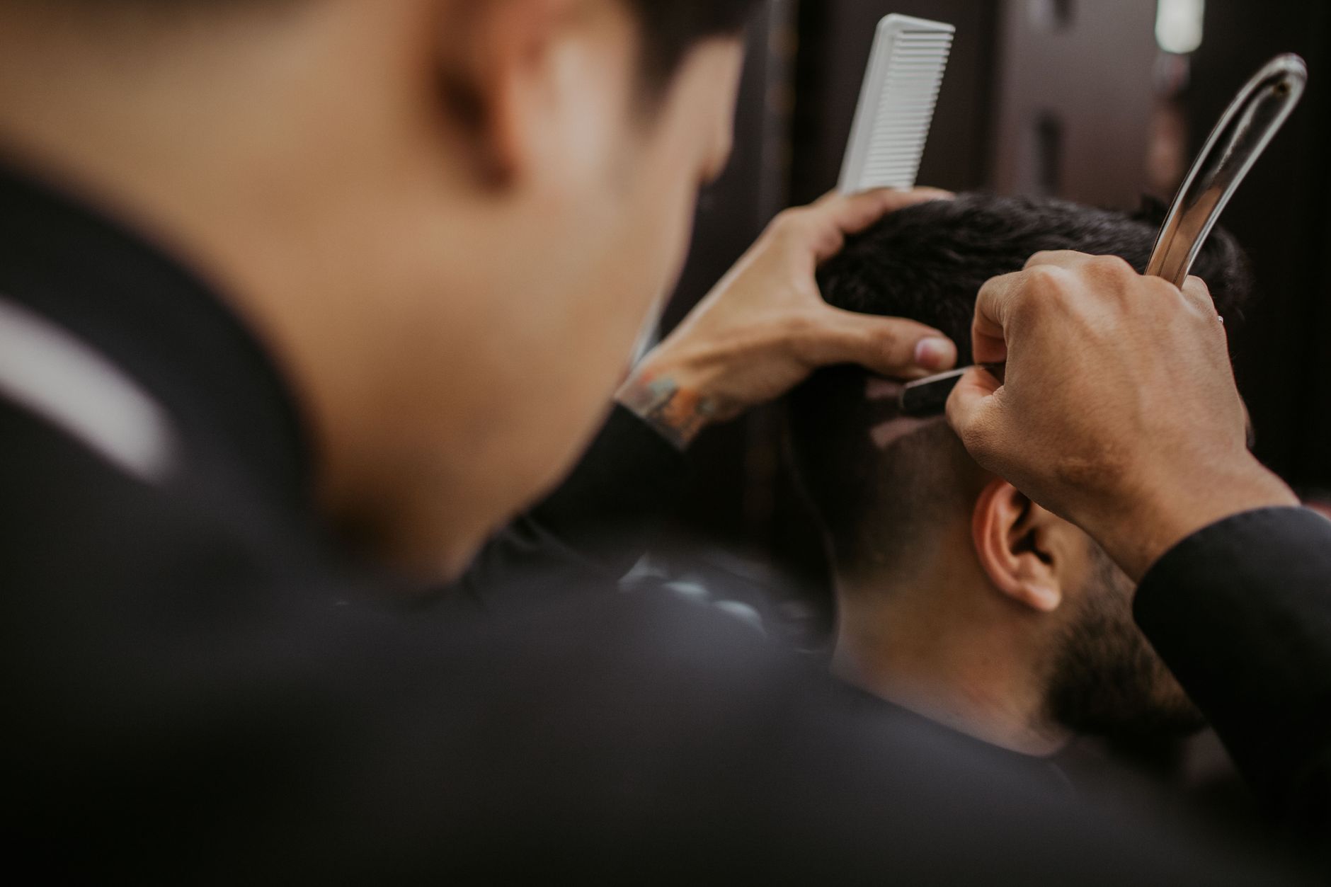 Barber giving a client a haircut in a barbershop