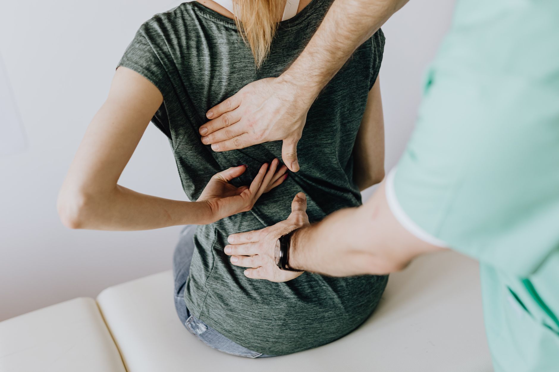 Chiropractor examining a patient's back