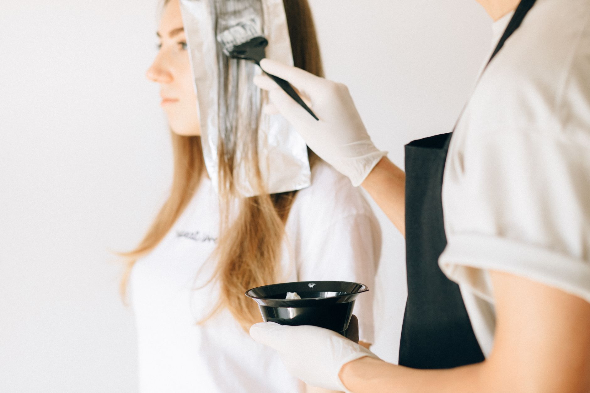 Client having hair colour applied in a salon