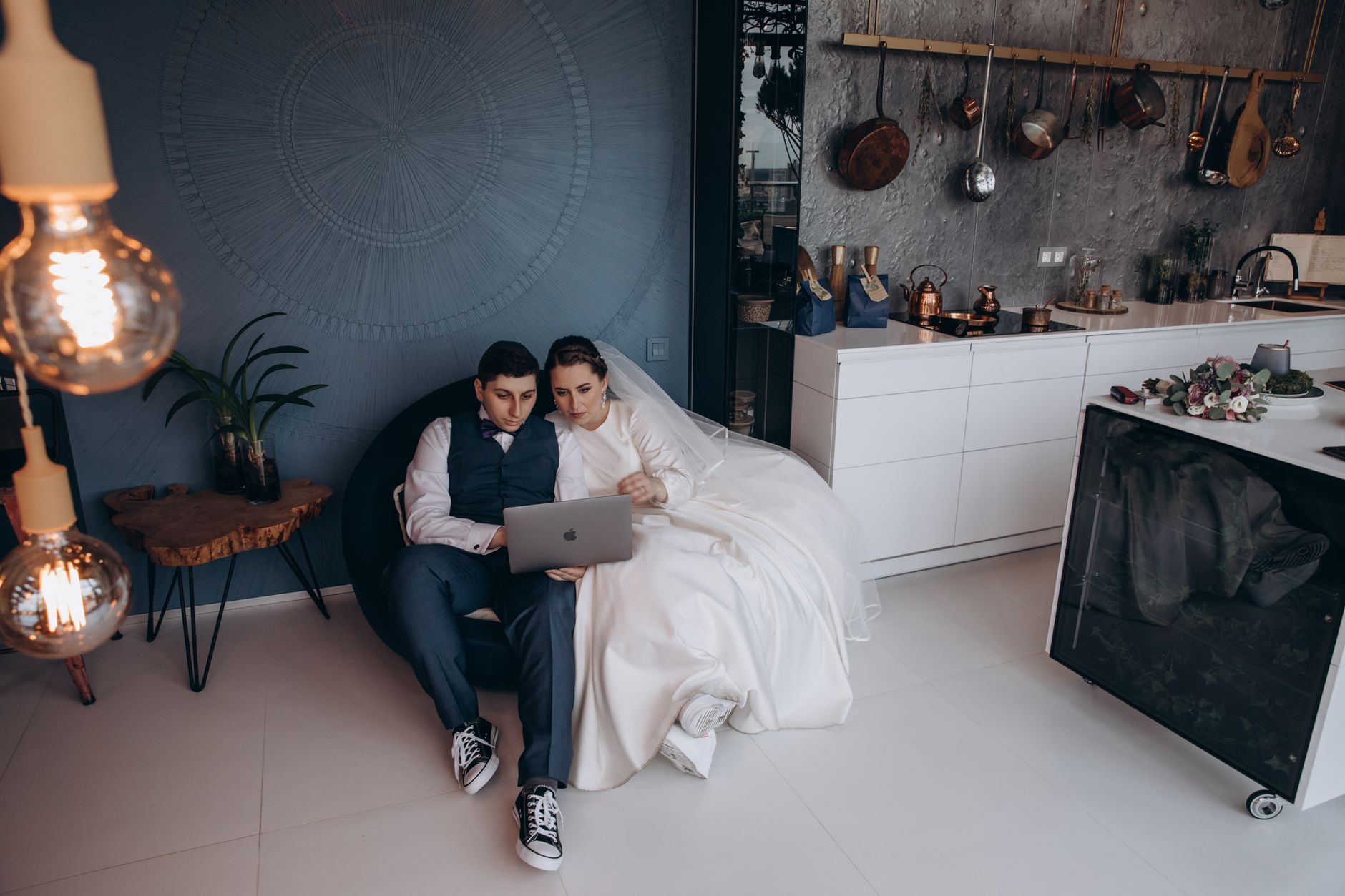 Couple looking at a laptop while planning their wedding