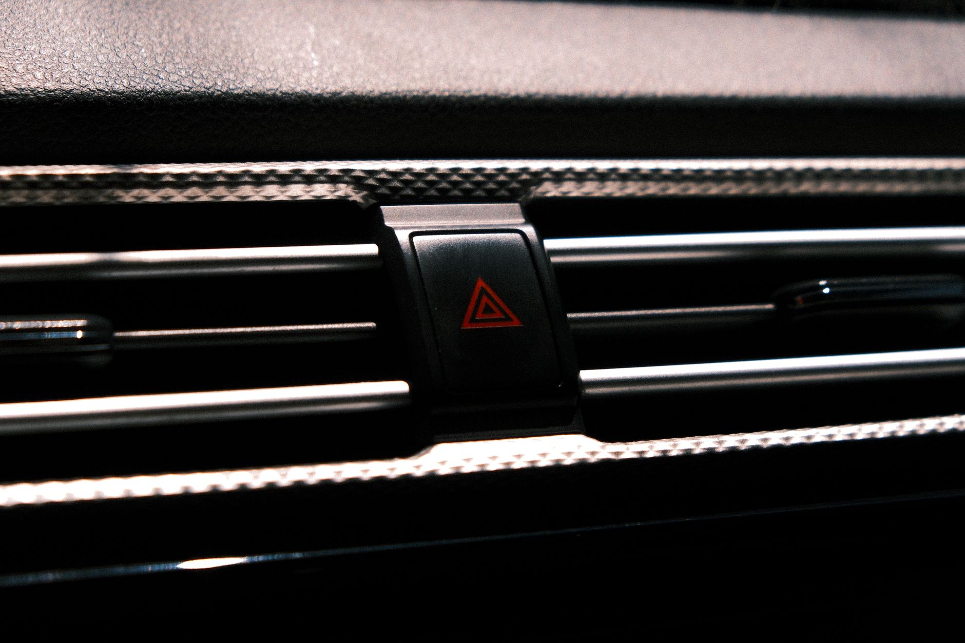 Driver checking a dashboard warning light in a car