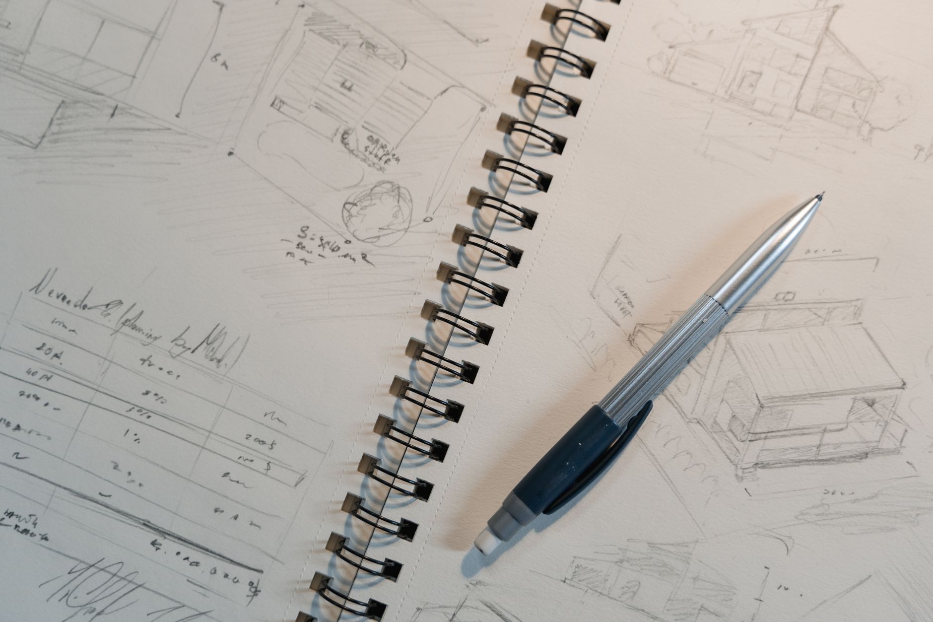 Garden designer discussing a design plan sketch with a client