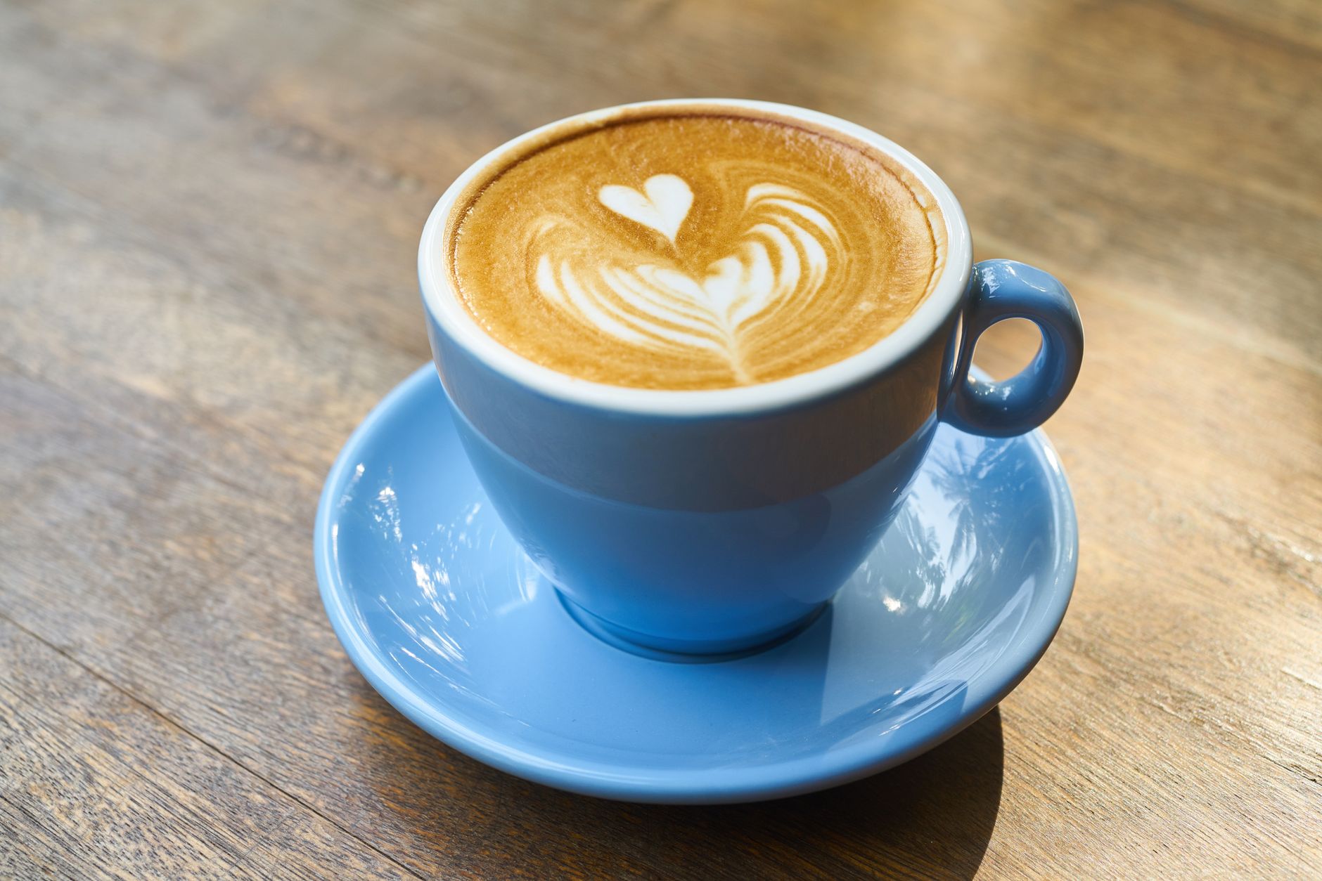 Latte art in a coffee cup on a cafe table