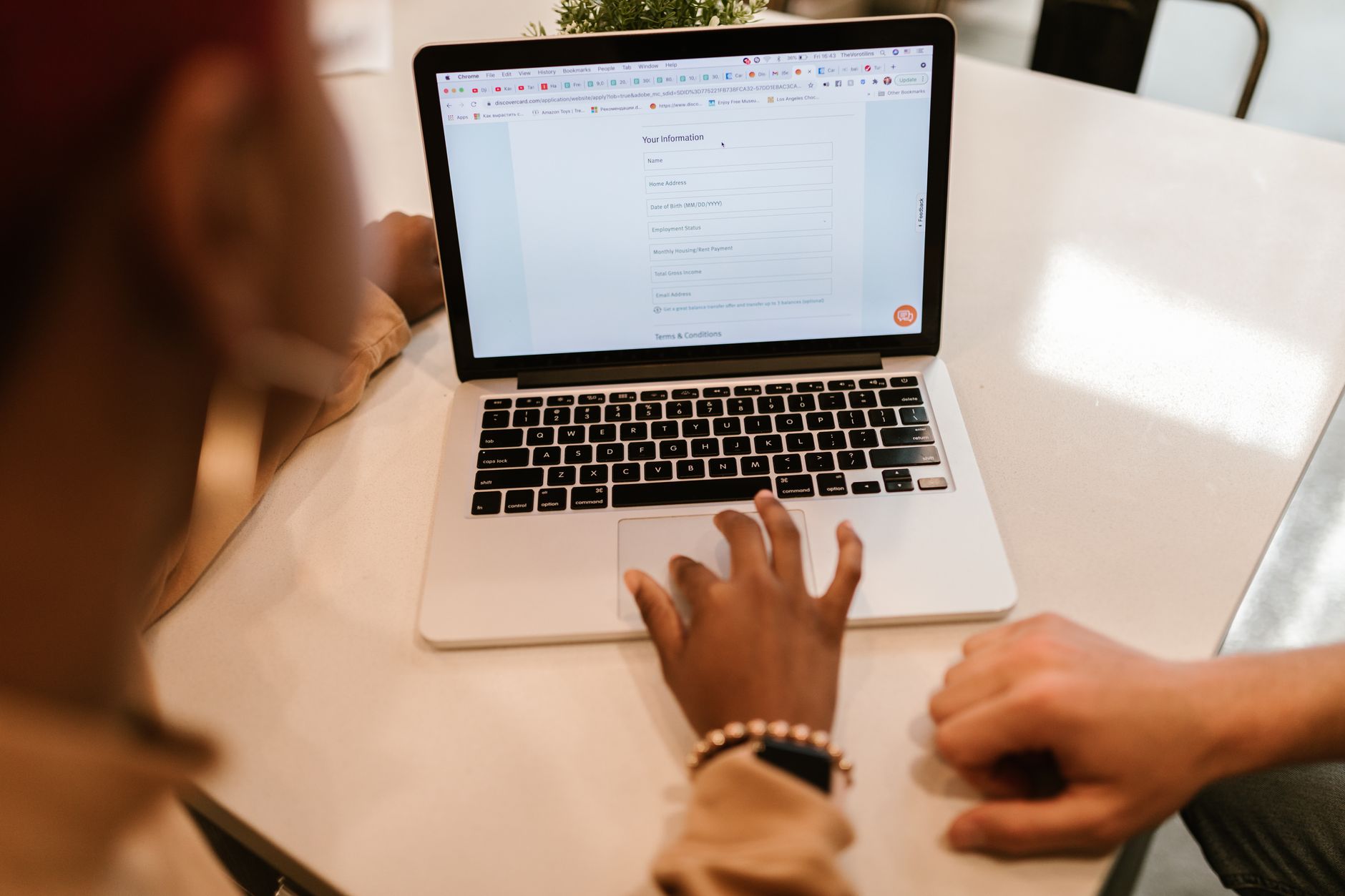Person filling in an online quote request form on a laptop