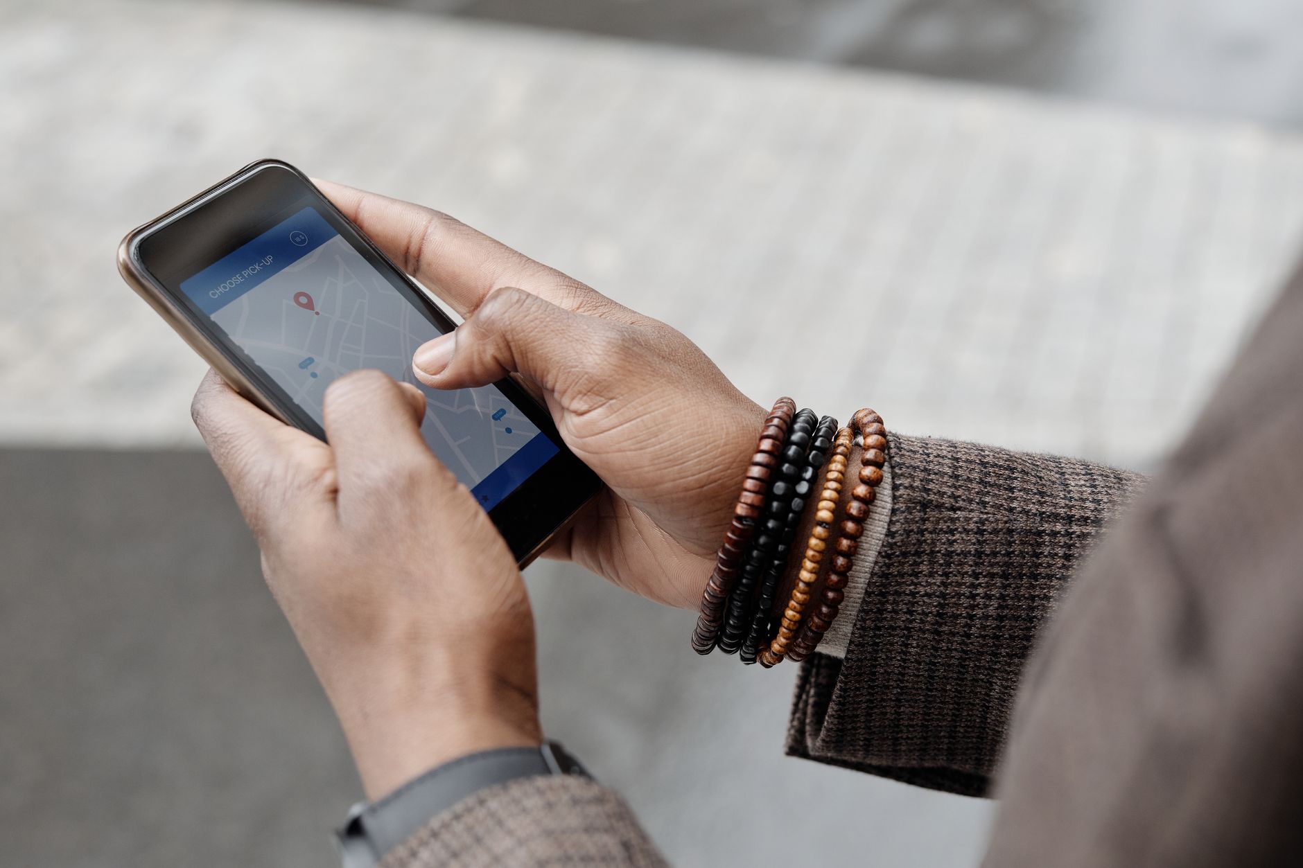 Person using a phone to search for directions on a map
