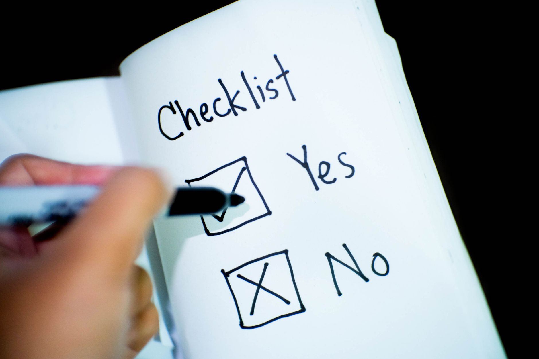 Person working through a checklist while comparing service providers