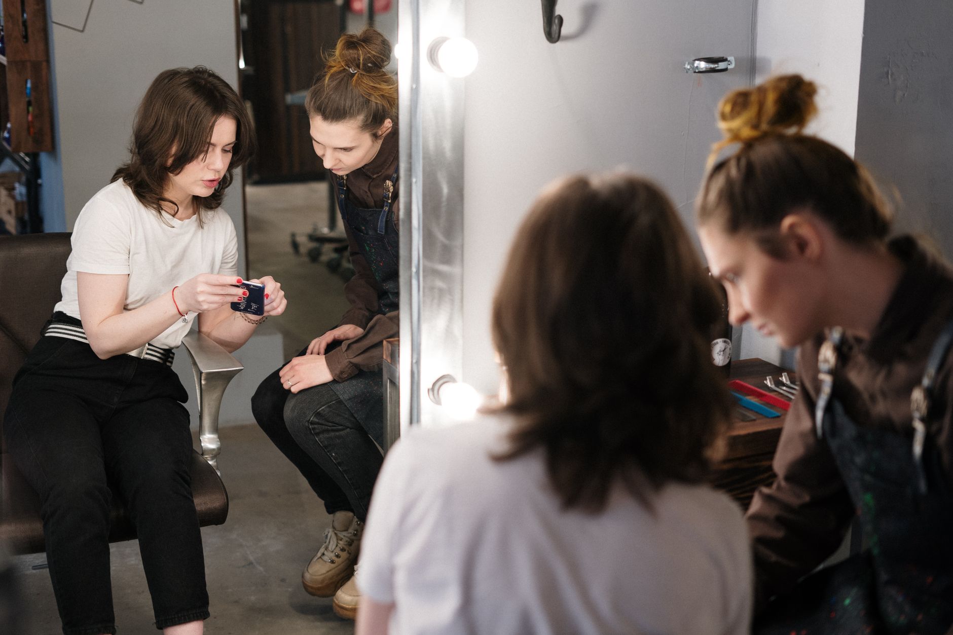 Stylist consulting with a client in front of a salon mirror