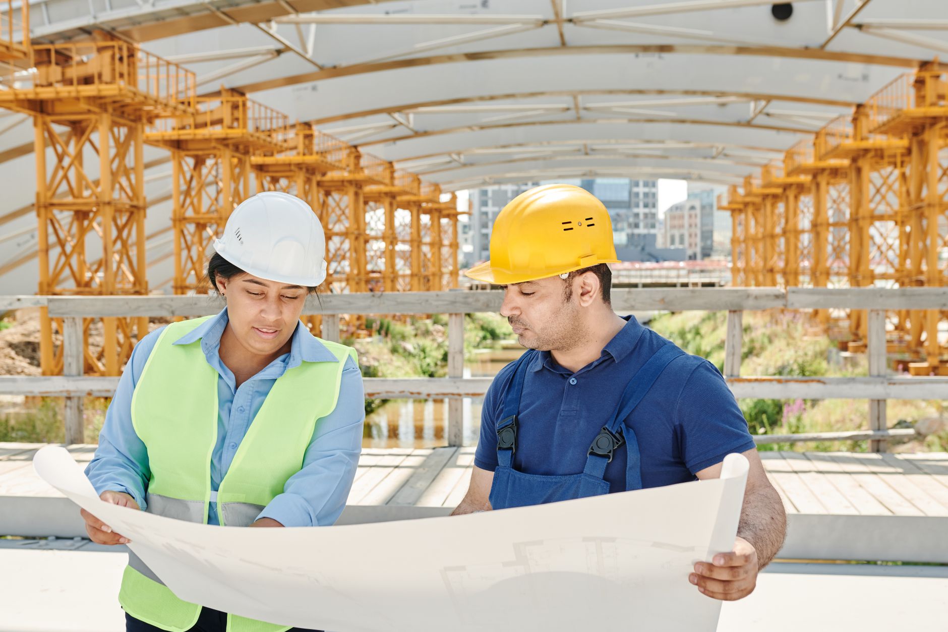 Builder reviewing blueprints on a construction site