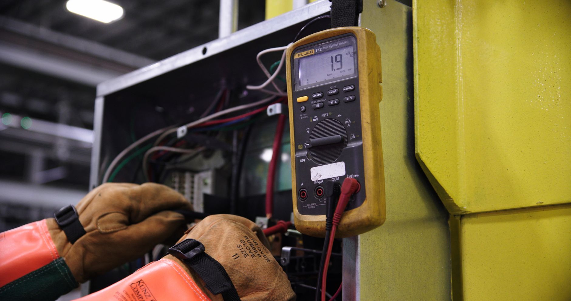 Electrician testing household wiring with a multimeter