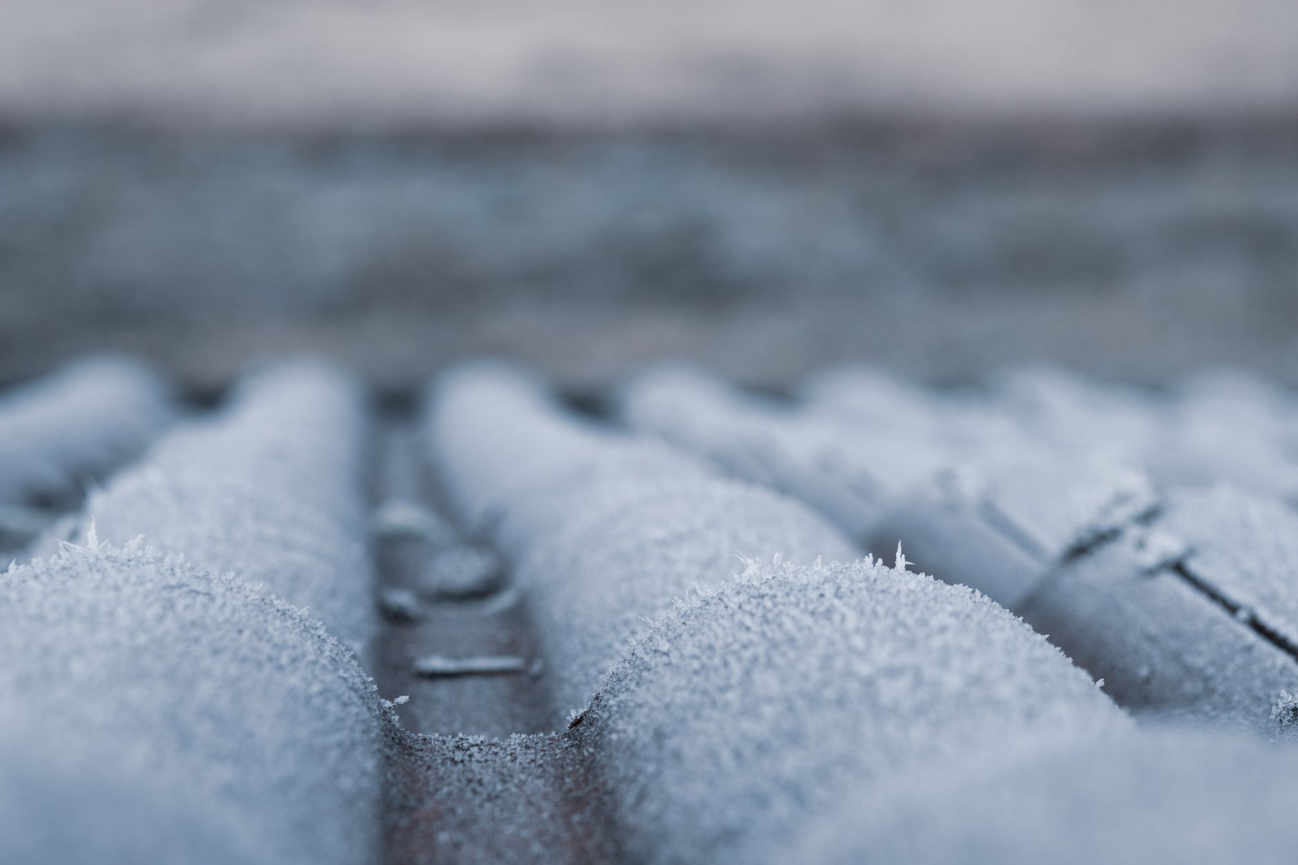 Frozen outdoor pipe covered in winter frost