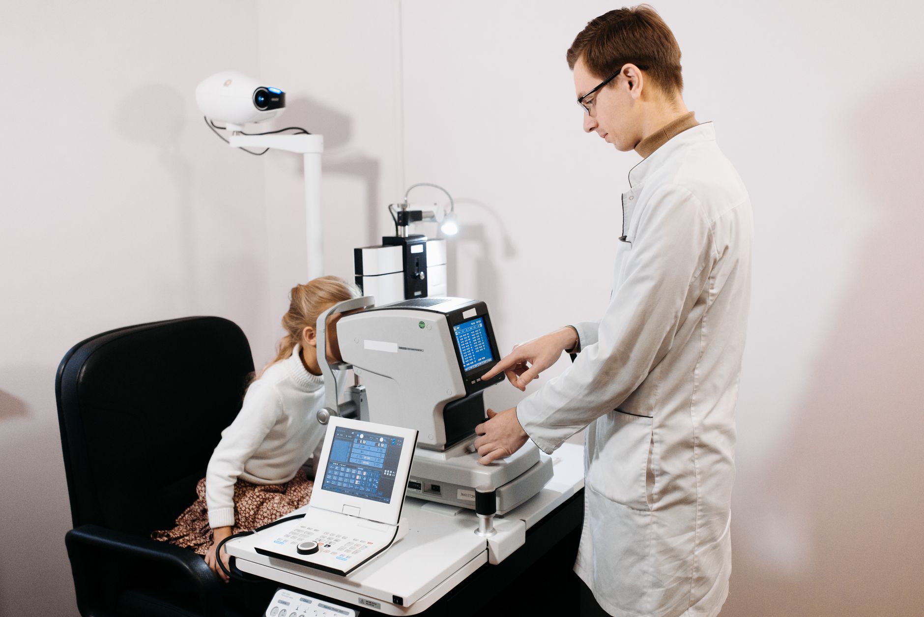 Optician carrying out an eye test in an examination room