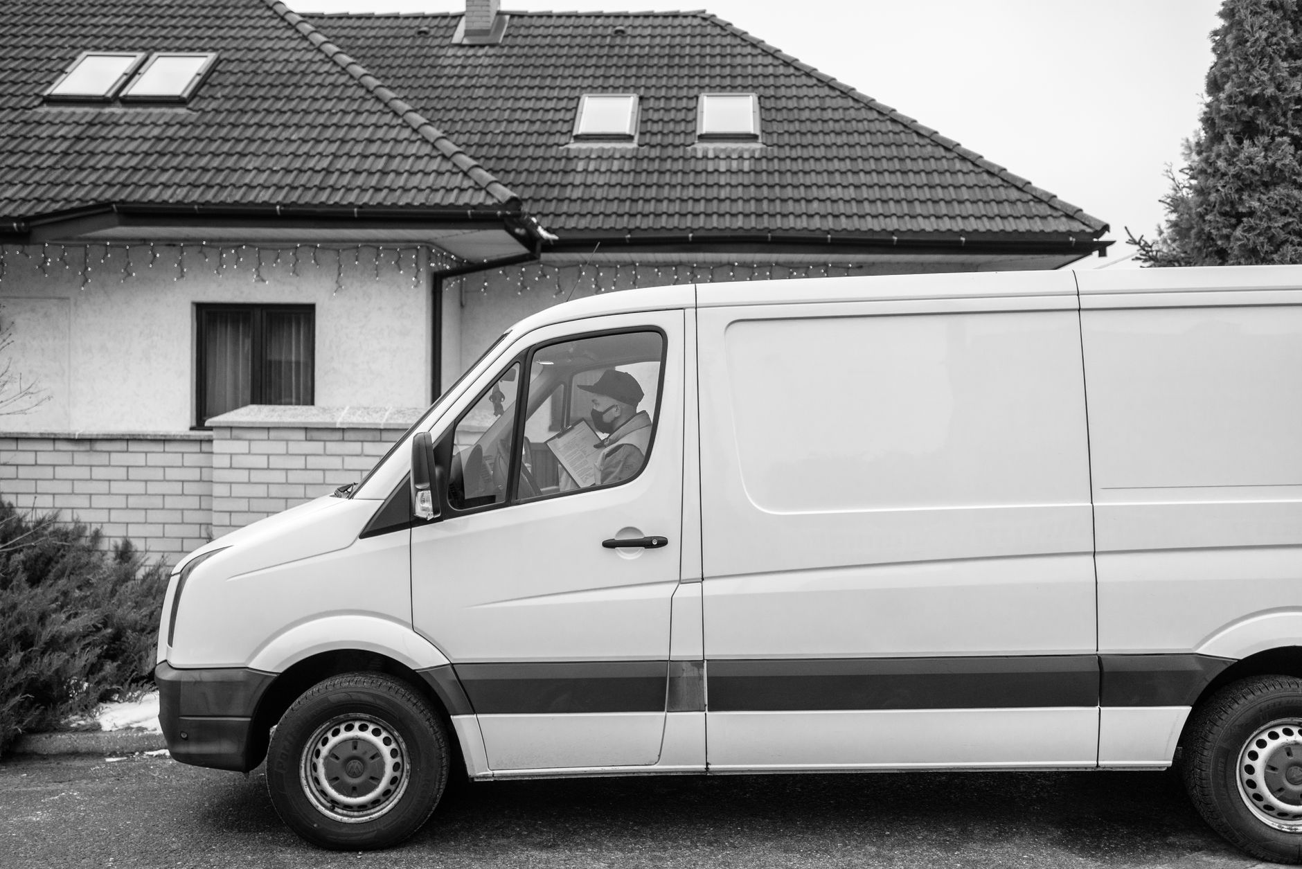 Plumbing company van parked outside a residential house